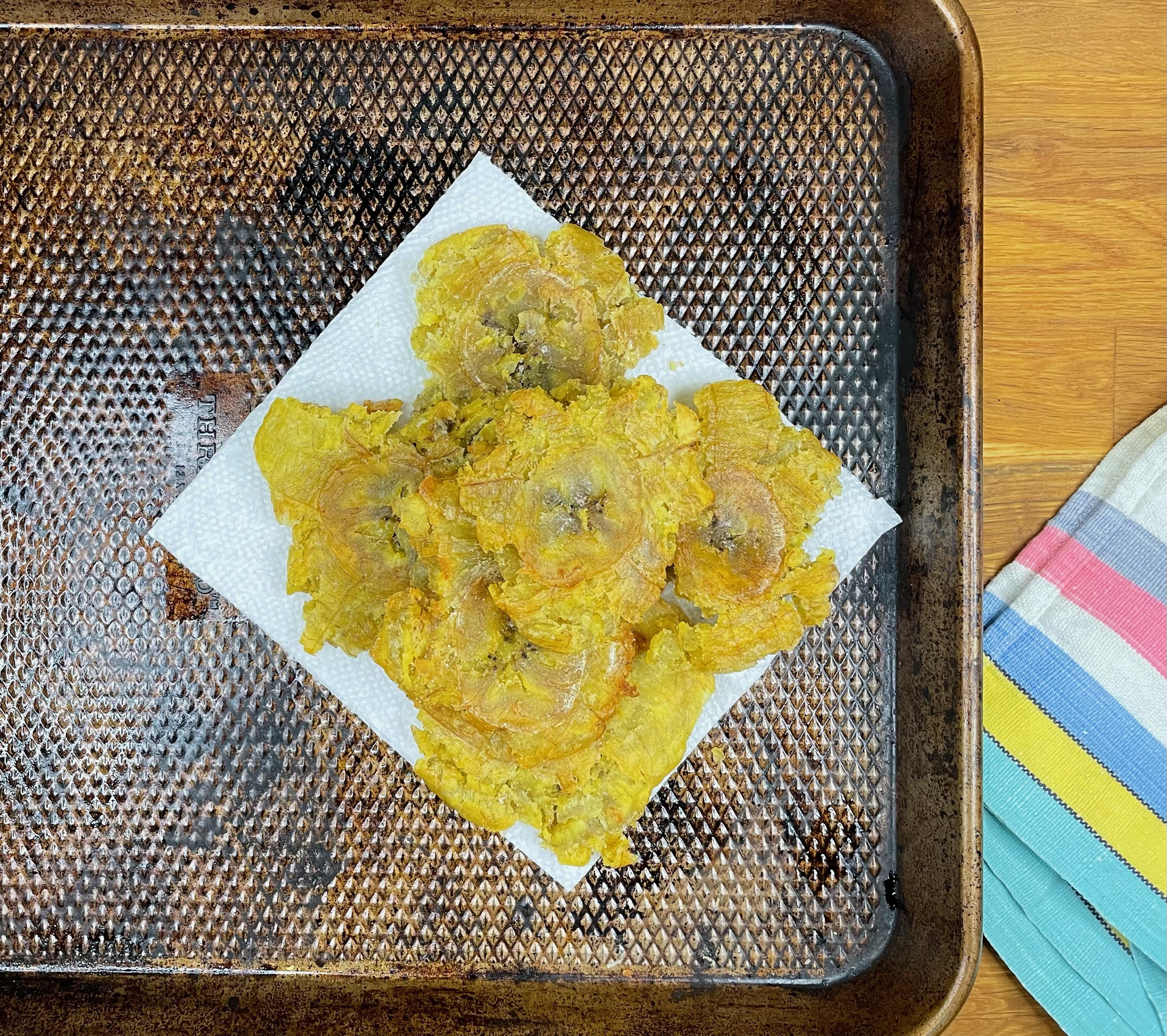 Fried plantains on a cookie sheet. 