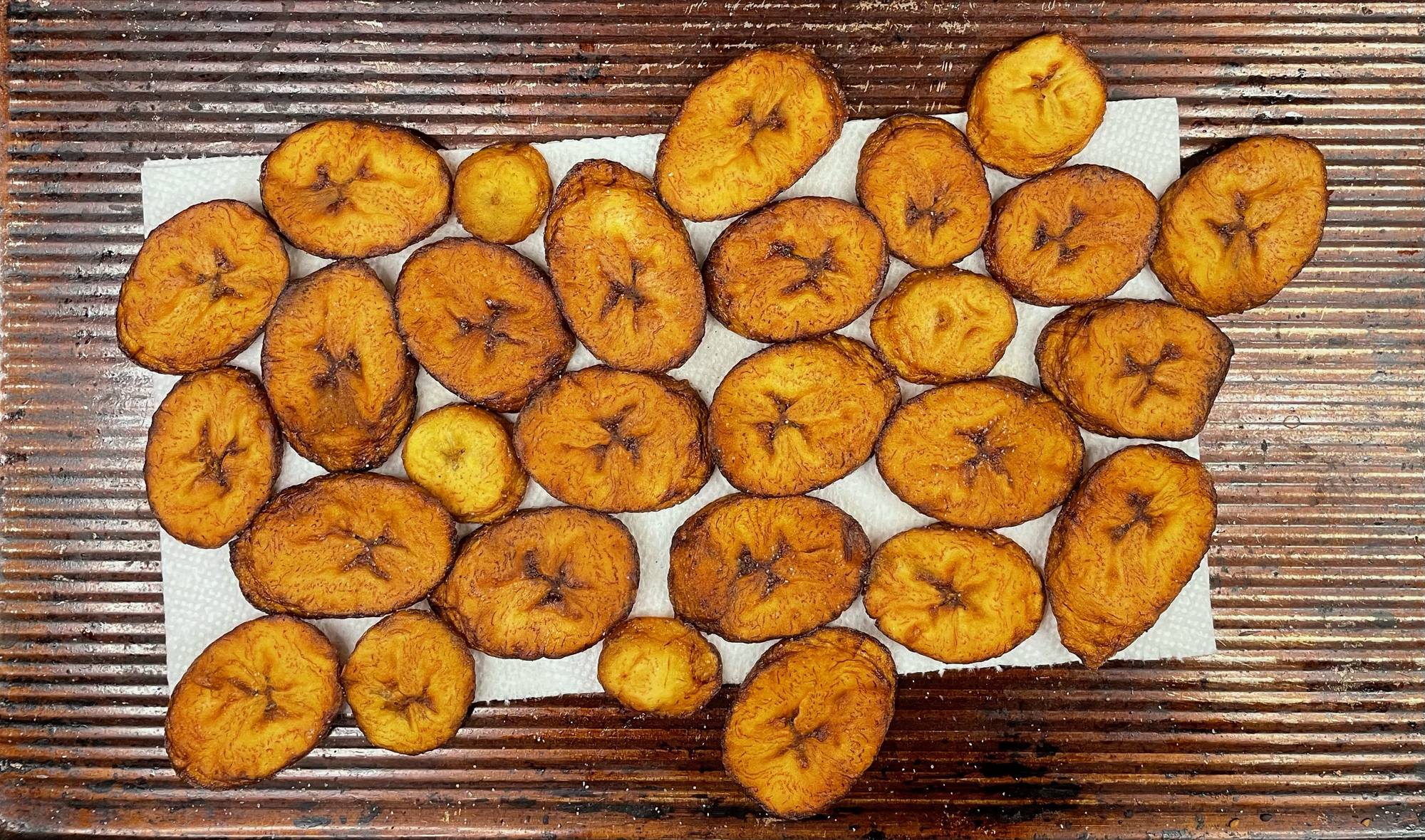 Fried sweet plantains on a cookie sheet. 